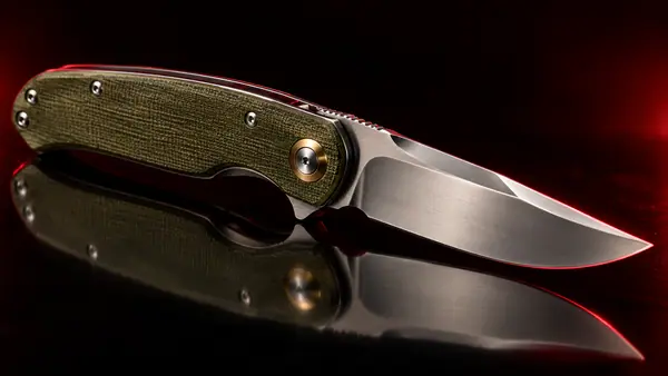 Illustrative studio render of a liner-lock folder with green micarta handle, not the actual model